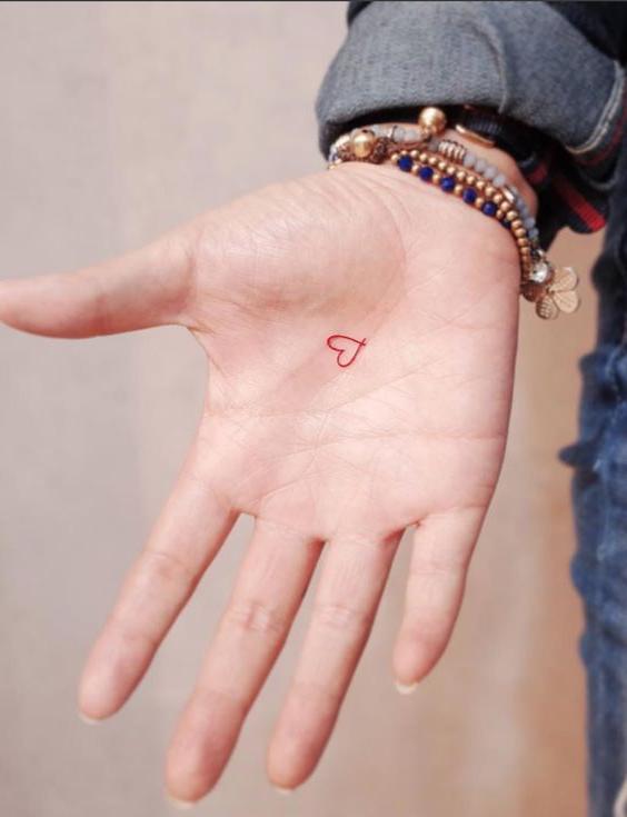 Red Outline Heart Tattoo on palm